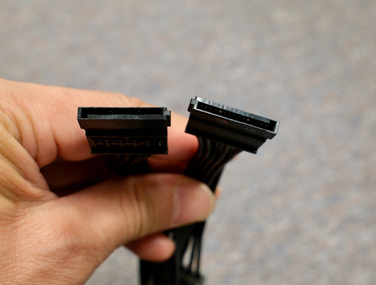 Hand holding the SATA connectors of the EVGA cable
