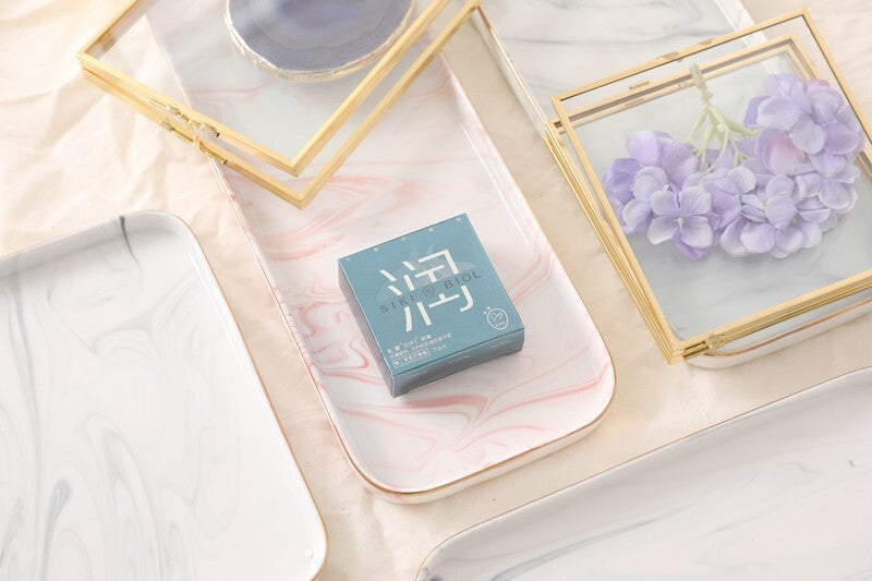 SIKI 003 light blue retail box on a marble tray with flowers