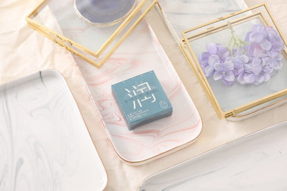 SIKI 003 light blue retail box on a marble tray with flowers