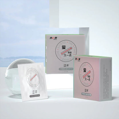 Drywell retail boxes and a condom wrapper beside a glass sphere